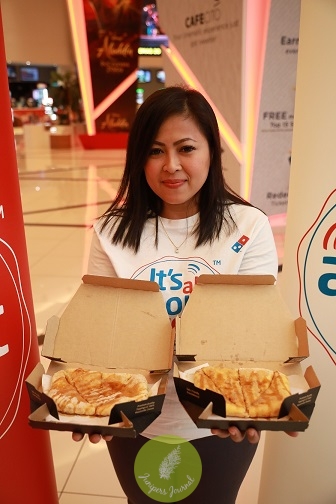 Linda Hassan, Senior Vice President of Marketing Domino's Pizza Malaysia and Singapore holding the Saranghae-ny Stix