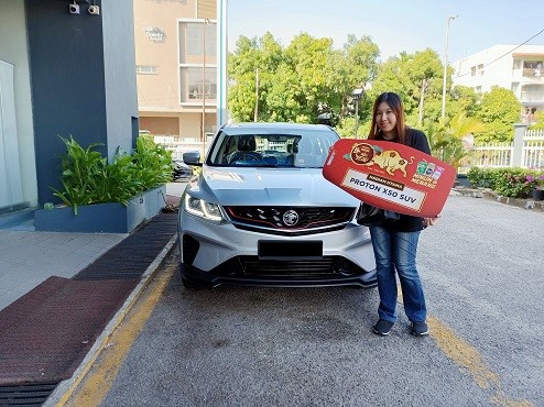 Ms Ooi Yun Lin from Georgetown, Penang is grateful to have won her first car, a brand new Proton X50 SUV as one of the Grand Prizes from Peraduan Nestlé Niu Year